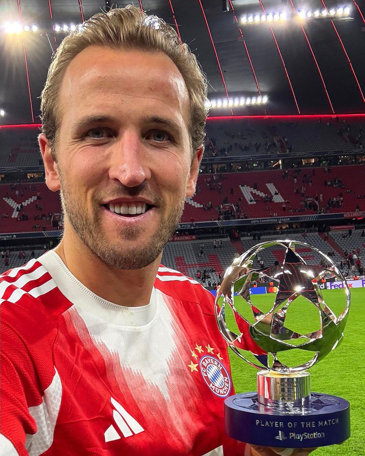 Bayern Munich forward, Harry Kane, poses with his Most Valuable Player (MVP) award