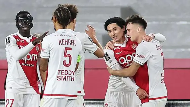 Japanese attacking midfielder, Takumi Minamino, celebrates goal for AS Monaco with teammates in the match against Champions of Europe, PSG