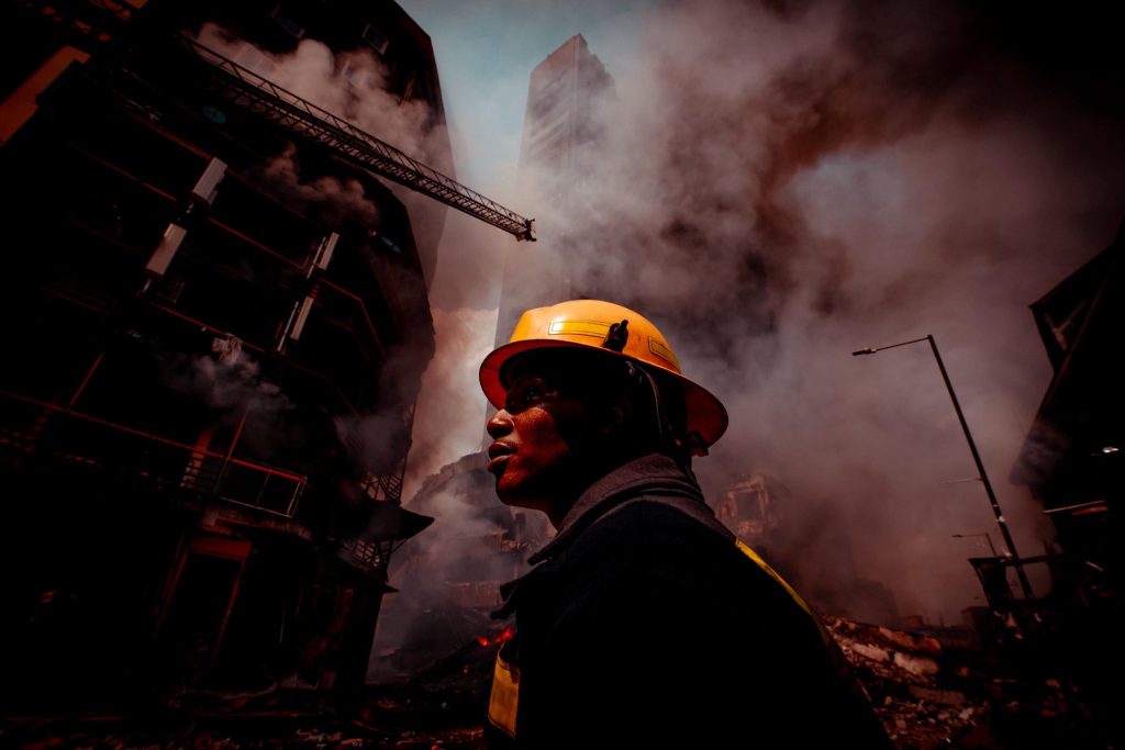 A firefighter at the scene of the Great Nigeria House fire incident in Balogun, Lagos Island