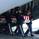 Members of a U.S. Army carry team move the flag-draped transfer case holding the remains of a US soldier of Fayetteville, North Carolina, during a dignified transfer at Dover Air Force Base July 22, 2026 in Dover, Delaware