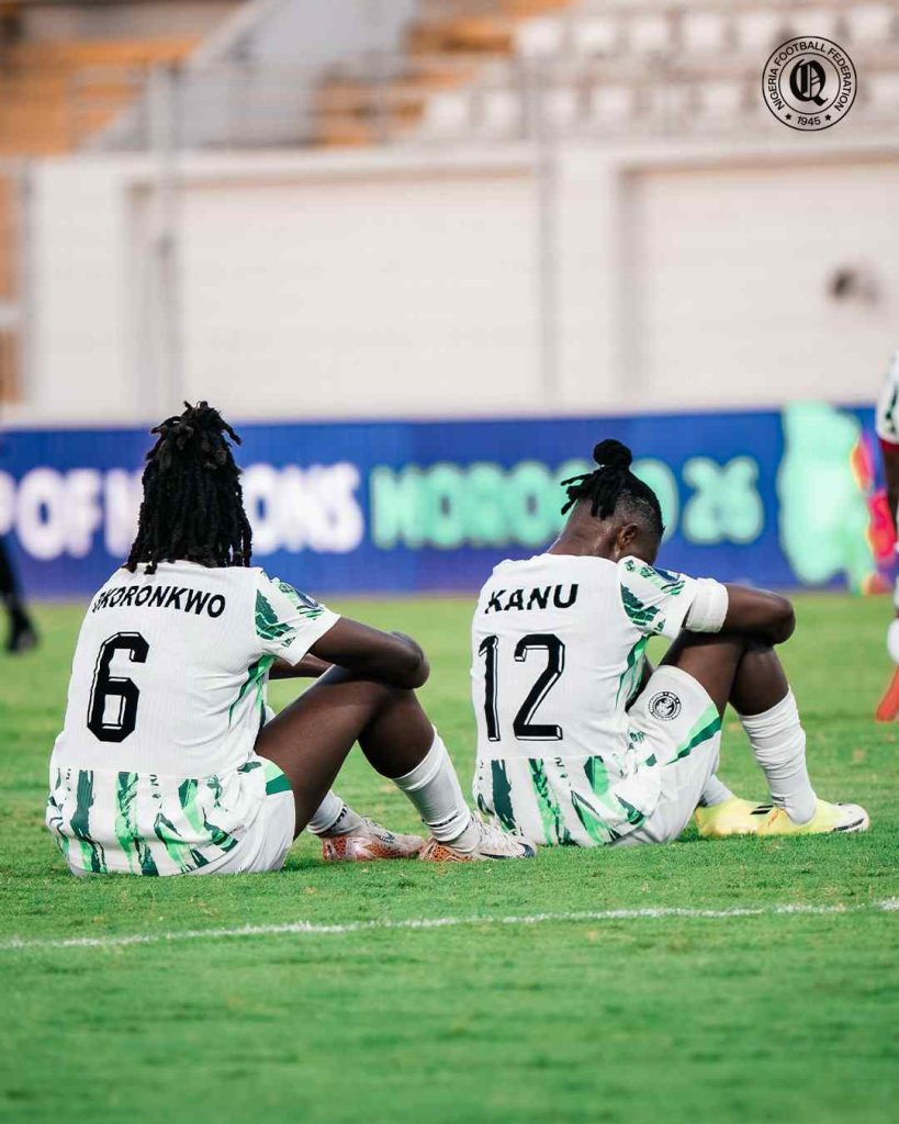 Super Falcons, Esther Okoronkwo and Uchenna Kanu, sitting on the pitch dejected after being knocked out of the CAF Women's Africa Cup of Nations (WAFCON) 2026 0-1 by Cameroon in the quarter finals in Casablanca, Morocco on Sunday 9 August, 2026 | NGSuper_Falcons/X